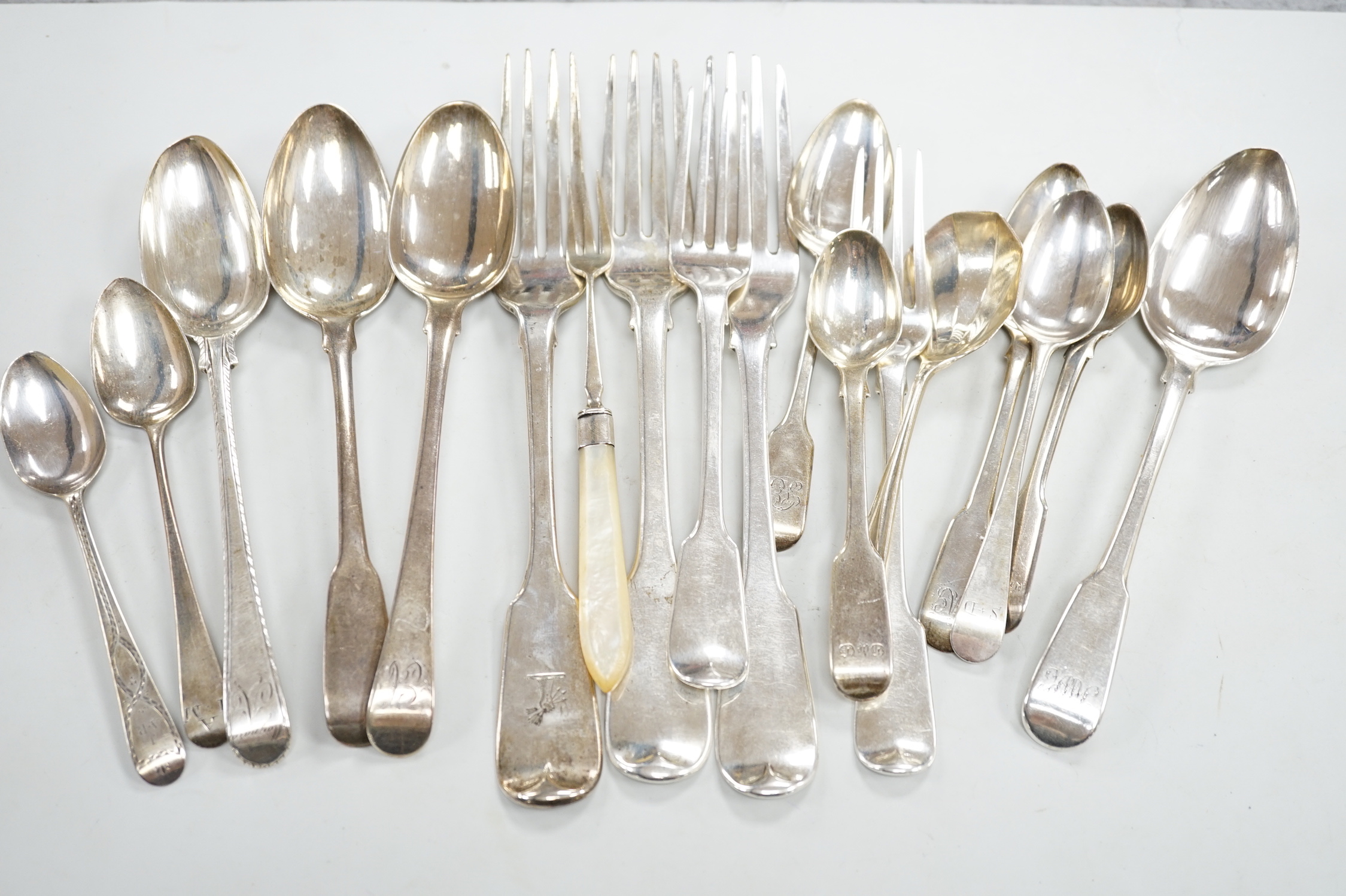 A George III silver Old English feather edge dessert spoon, London, 1775 and a small quantity of assorted mainly 19th century silver flatware including an Irish table fork, various patterns, makers and dates, 18.5oz.